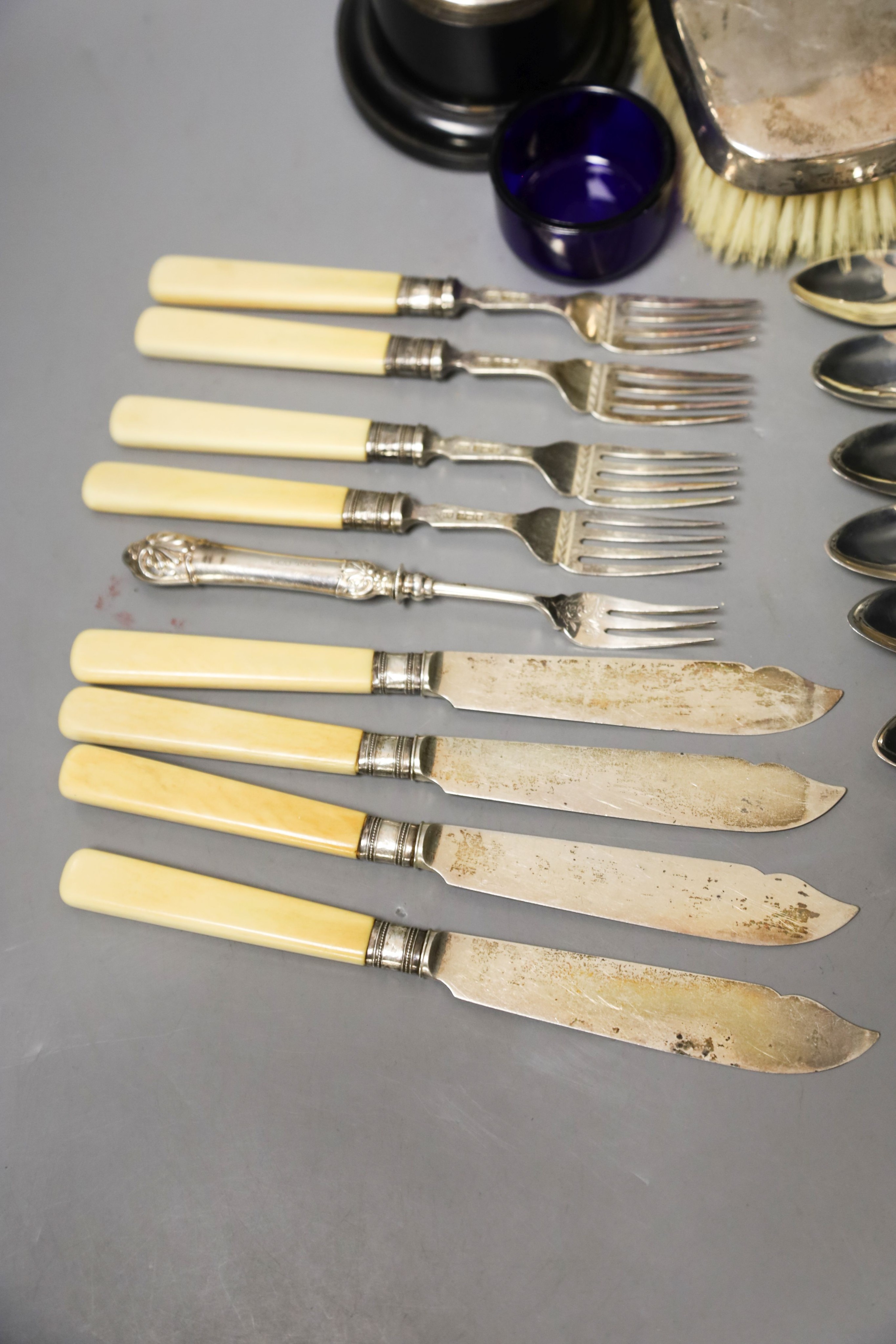 A pair of silver mounted clothes brushes, a silver two handled trophy cup and sundry flatware.